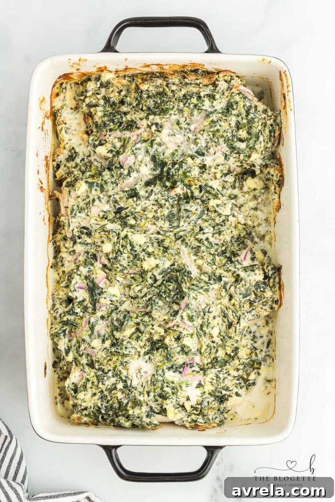 Creamy Spinach Chicken Bake 5 Spreading spinach dip mixture over chicken