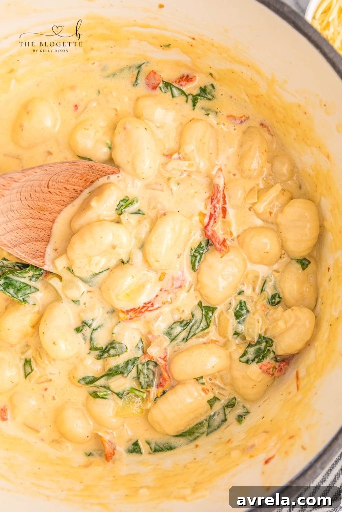 Creamy Tuscan Gnocchi - Soft gnocchi cooked in a cream sauce with sun-dried tomatoes, spinach, and garlic. Done in just 20 minutes!