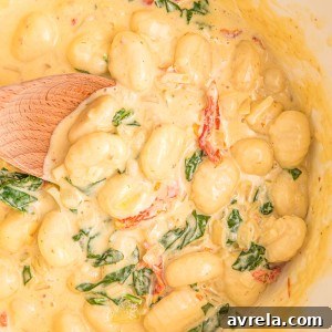 Creamy Tuscan Gnocchi - Soft gnocchi cooked in a cream sauce with sun-dried tomatoes, spinach, and garlic. Done in just 20 minutes!