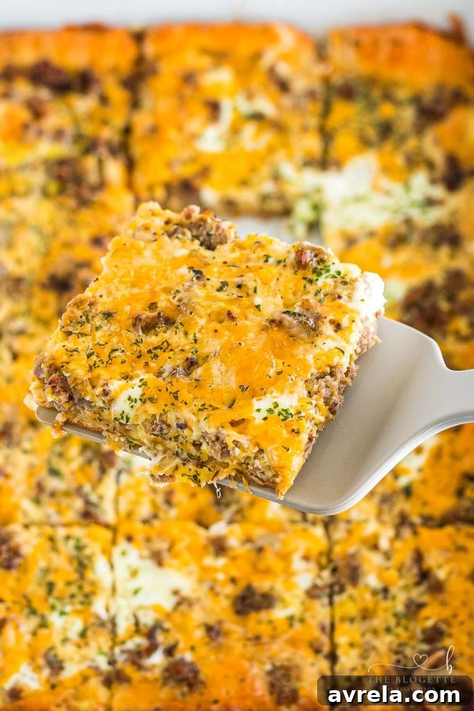 The best Breakfast Sausage Casserole with a layer of cheese, eggs, crescent dough, and sausage!