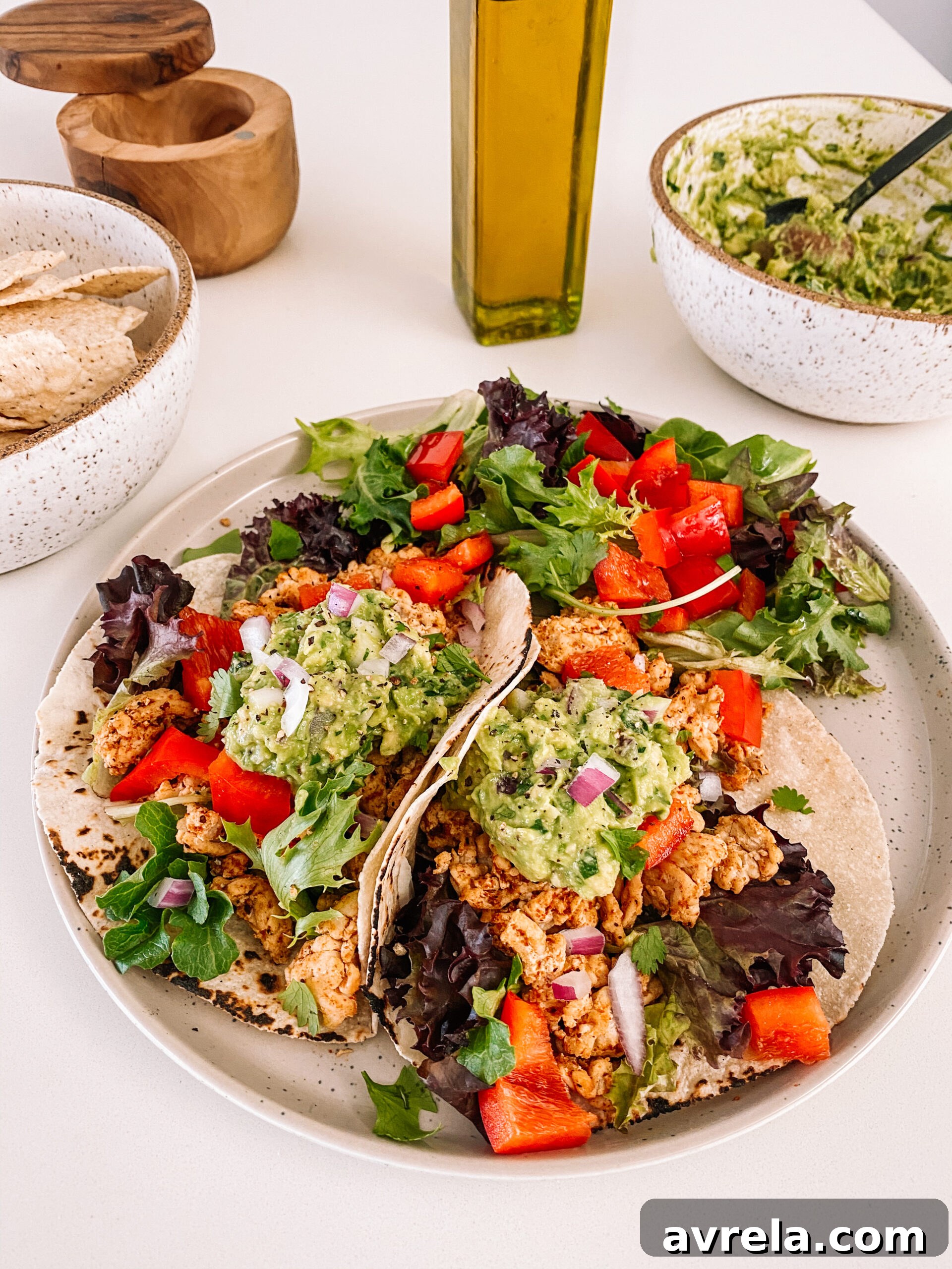 Delicious 20-Minute Tacos generously topped with fresh guacamole and vegetables