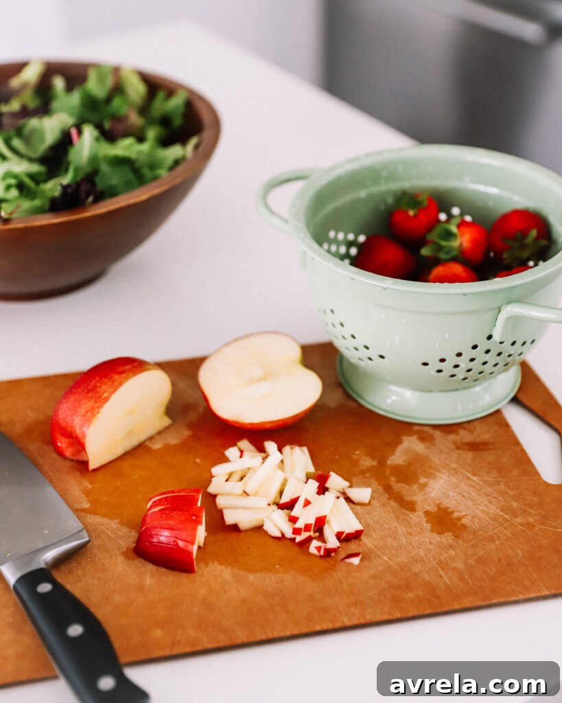 A refreshing summer salad with matchstick cut fruits and goat cheese