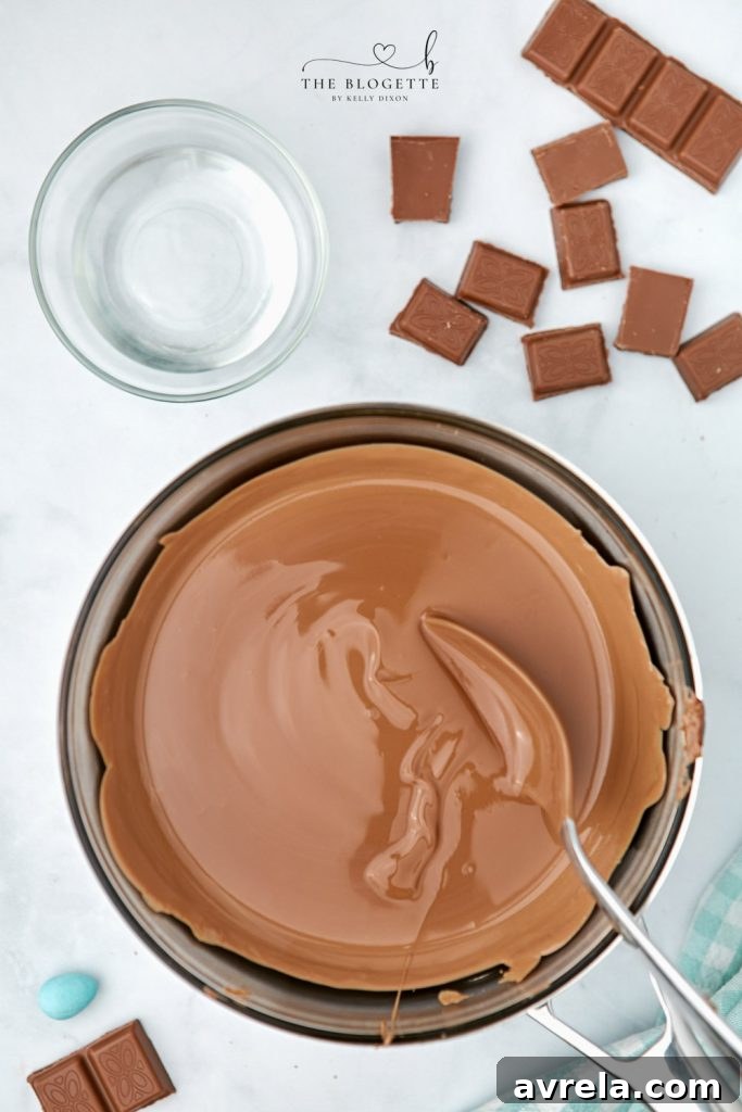 Bowl of perfectly melted chocolate, smooth and glossy, ready to be mixed with cornflakes for Easter egg nests.