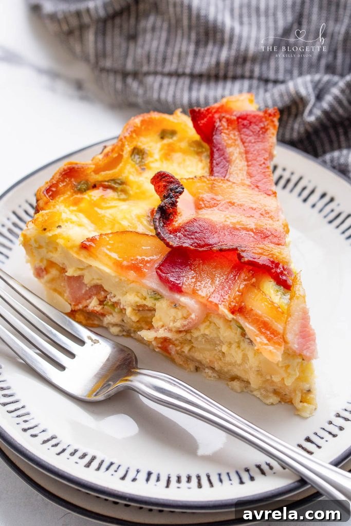 Maple Glazed Bacon Breakfast Bake 13 Close-up of a single slice of Maple Bacon Breakfast Pie on a plate, showing the layers and crispy bacon topping.