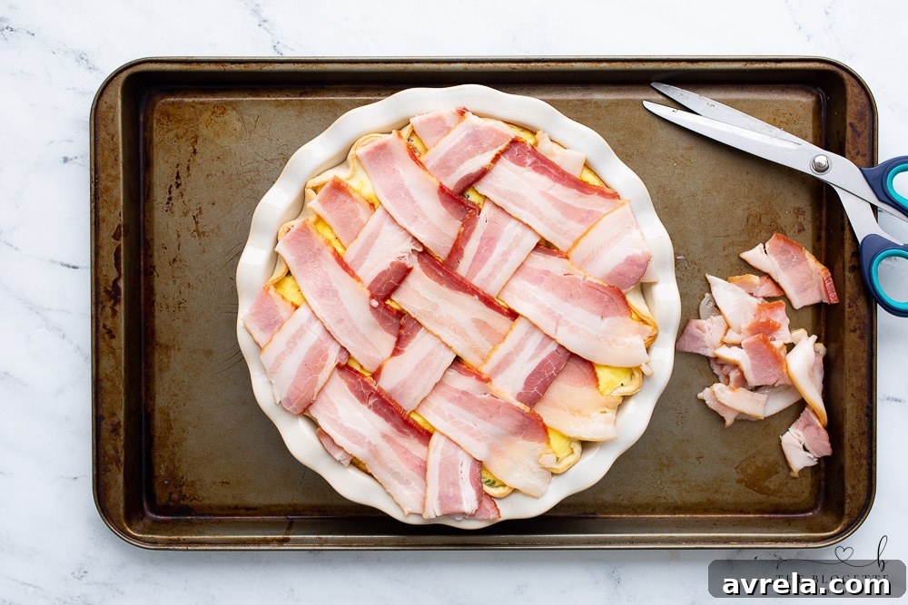 Maple Glazed Bacon Breakfast Bake 10 Maple Bacon Breakfast Pie with a bacon lattice, placed on a sheet pan, ready for the final bake.
