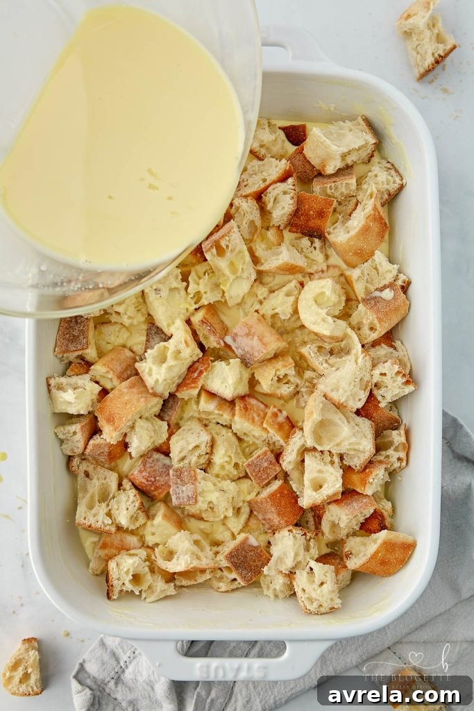 Morning Glory French Toast Bake 7 The bread cubes in a baking dish fully covered with the creamy egg mixture, ready for refrigeration.