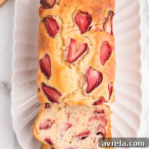 Sweet and soft Strawberry Bread is a spring and summer staple treat! Made with fresh strawberries, this quick bread recipe is the perfect way to enjoy strawberries while they're in season.