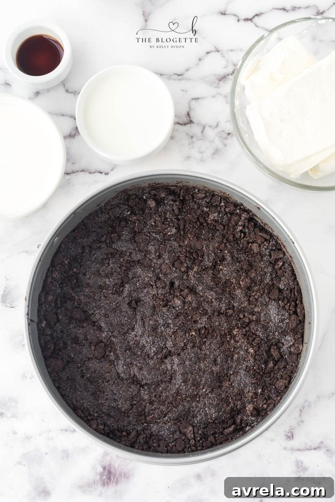 Oreo Dream Cheesecake 4 A bowl of crushed Oreo cookies mixed with melted butter, ready to be pressed into a pie crust, illustrating the homemade Oreo pie crust step.