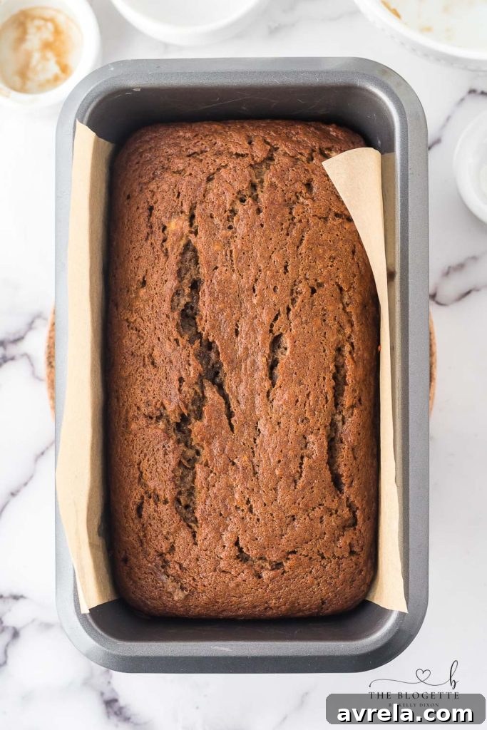 Moist Chocolate Chip Banana Loaf 9 A freshly baked, golden-brown loaf of Chocolate Banana Bread on a cooling rack.