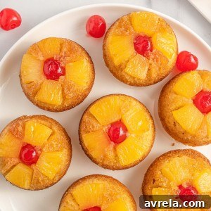 Easy Pineapple Upside Down Cupcakes Recipe! Soft, buttery sweet cupcakes with a moist top, tender pineapple pieces, and cherry on top.