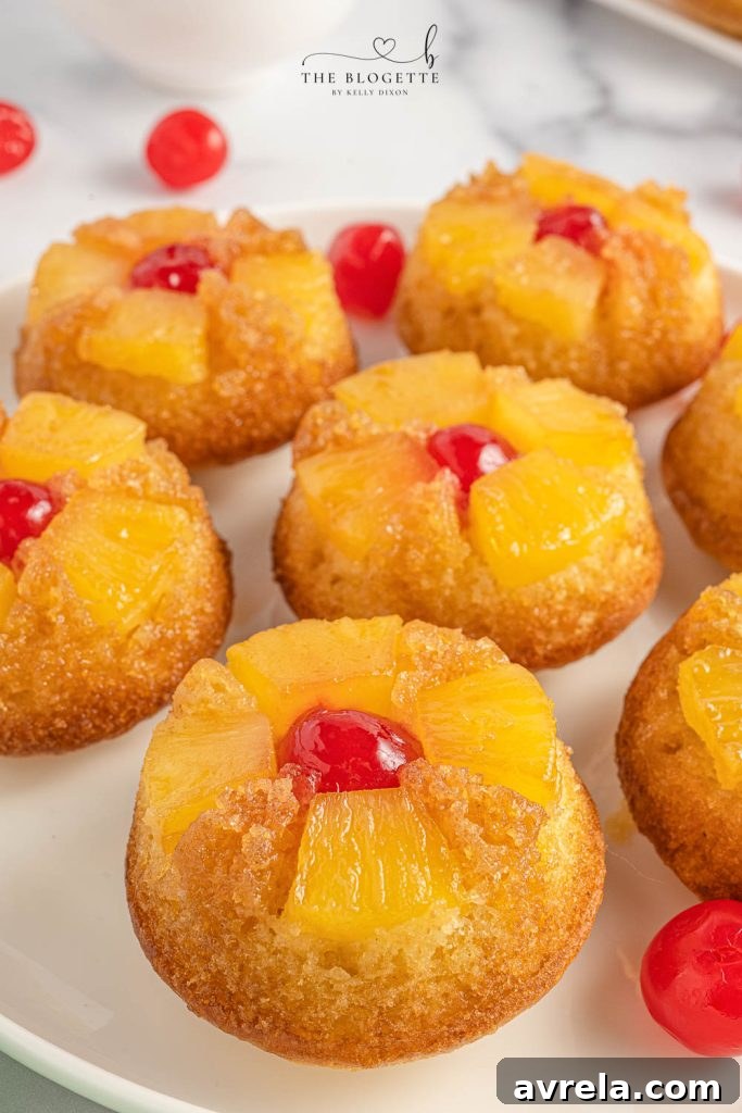 Easy Pineapple Upside Down Cupcakes Recipe! Soft, buttery sweet cupcakes with a moist top, tender pineapple pieces, and cherry on top.