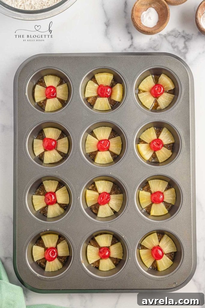 pineapples and cherries in a cupcake pan