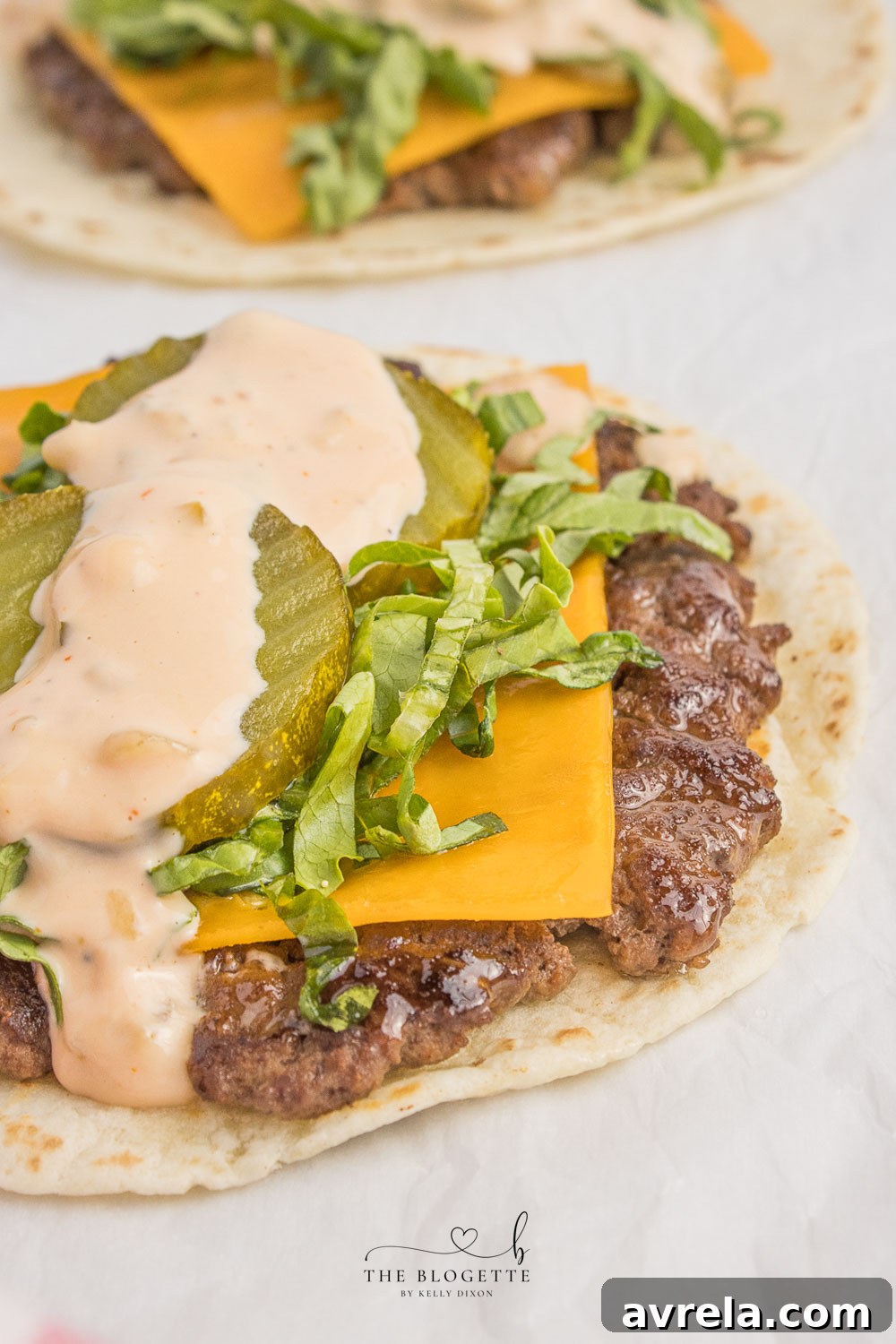 Double-Decker Taco 3 Big Mac Tacos! Juicy beef patty, melted cheddar, topped with an easy-to-make homemade Big Mac sauce! Add Taco Burgers to your menu tonight!