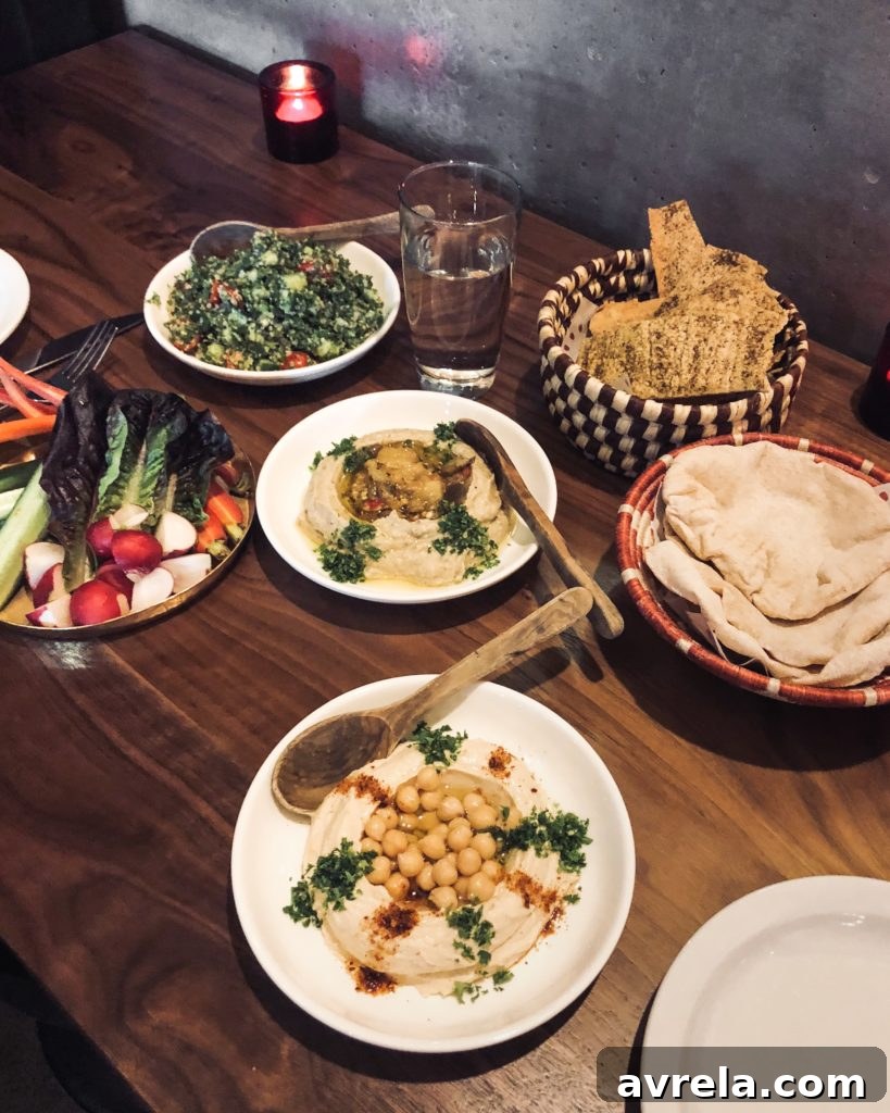 Hummus, baba ganoush, fresh pita, gluten-free crackers, tabbouleh, and crudité at Mamnoon