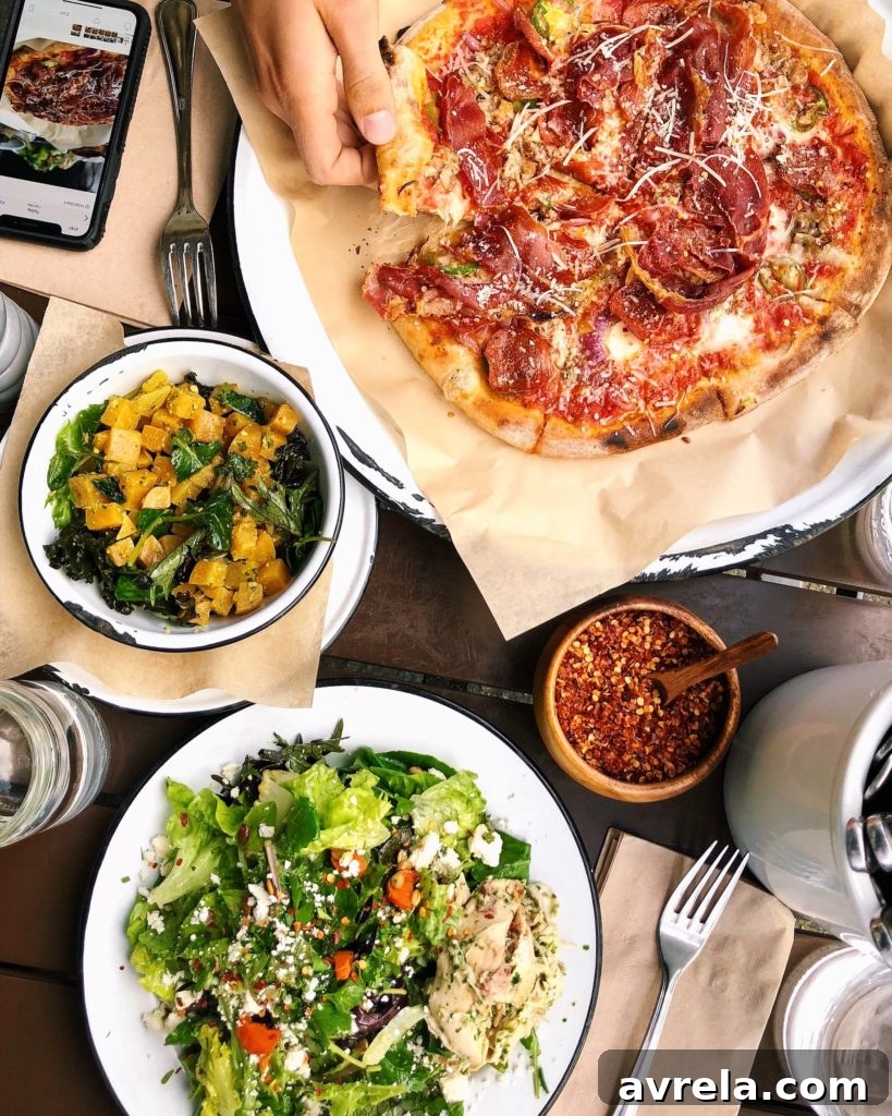 Wood-fired meat pizza, farm salad with roasted chicken, beets, and pistachio pesto from Deru Market