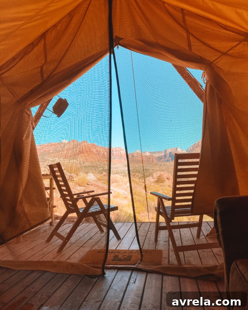 Inside a glamping tent at Under Canvas Zion, showing the bed and seating