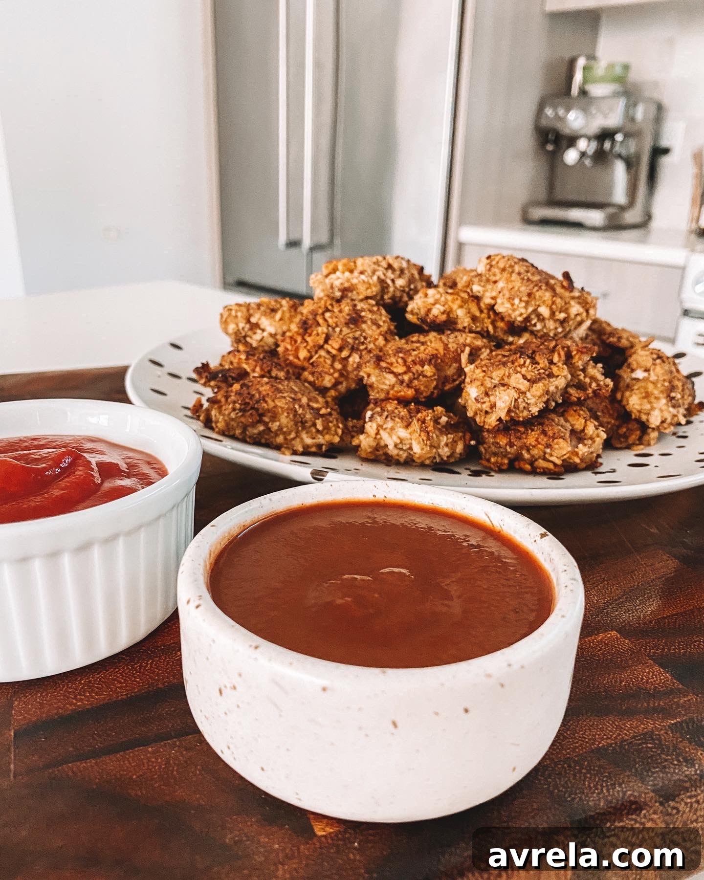 Delicious homemade crispy chicken nuggets on a plate with dipping sauce