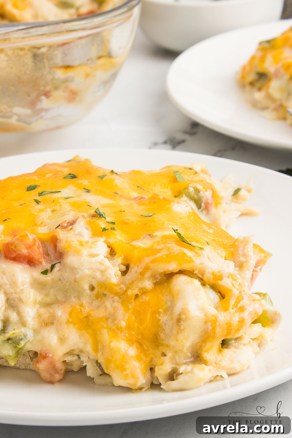 King Ranch Chicken Casserole is a combination of chicken, cheese, veggies, and corn tortillas in a rich and creamy sauce.