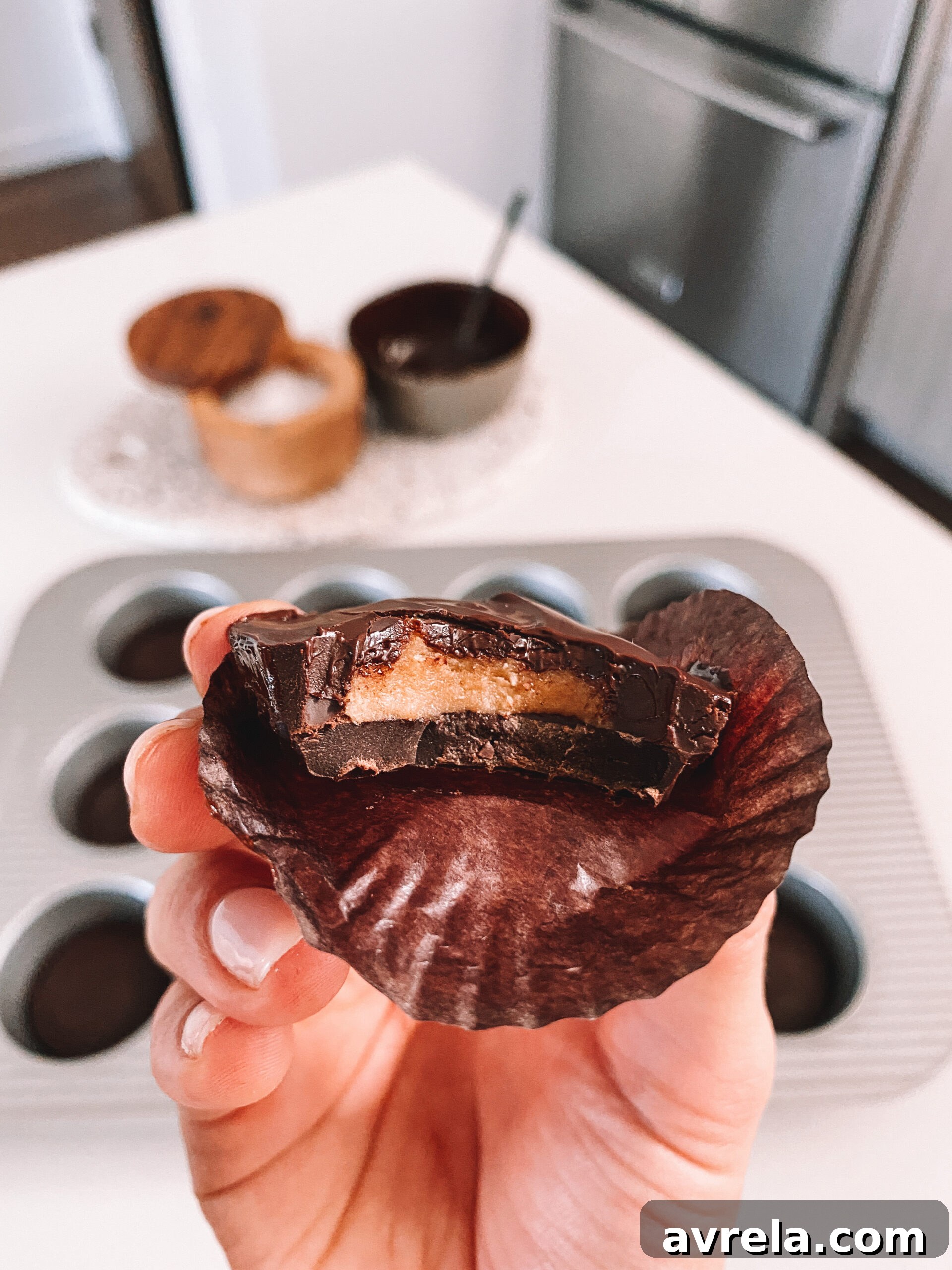 A stack of perfectly crafted homemade Reese's Peanut Butter Cups, each with a rich chocolate exterior and creamy peanut butter filling, ready for enjoyment.
