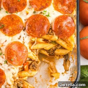 Pizza casserole with layers of pasta, sauce, and ooey-gooey cheese, along with your favorite pizza toppings.