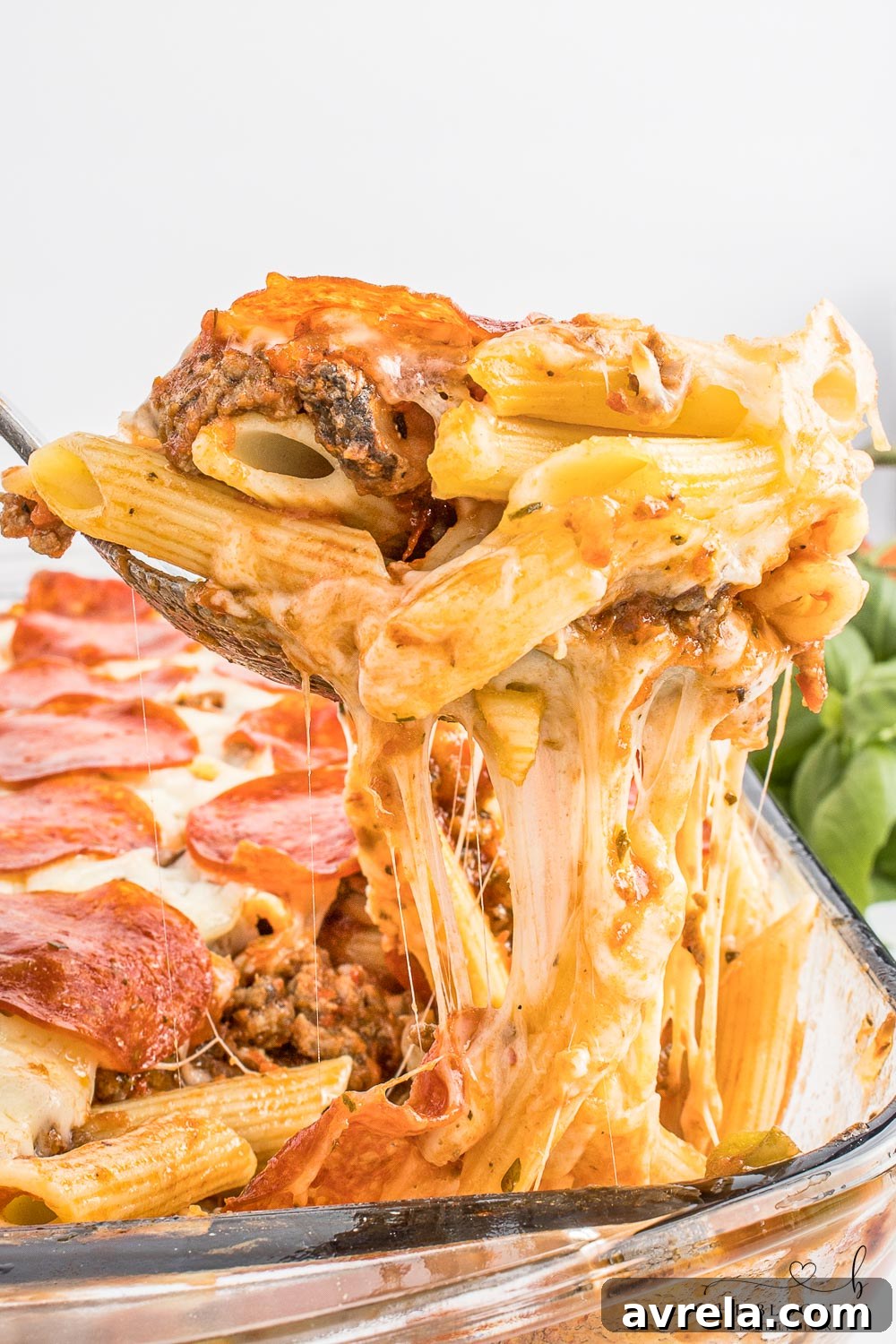 Close-up of a bubbling pizza casserole with rich layers of ingredients.
