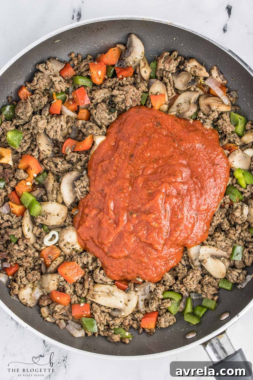 Sautéed ground beef and vegetables, forming the savory meat mixture for the pizza casserole.
