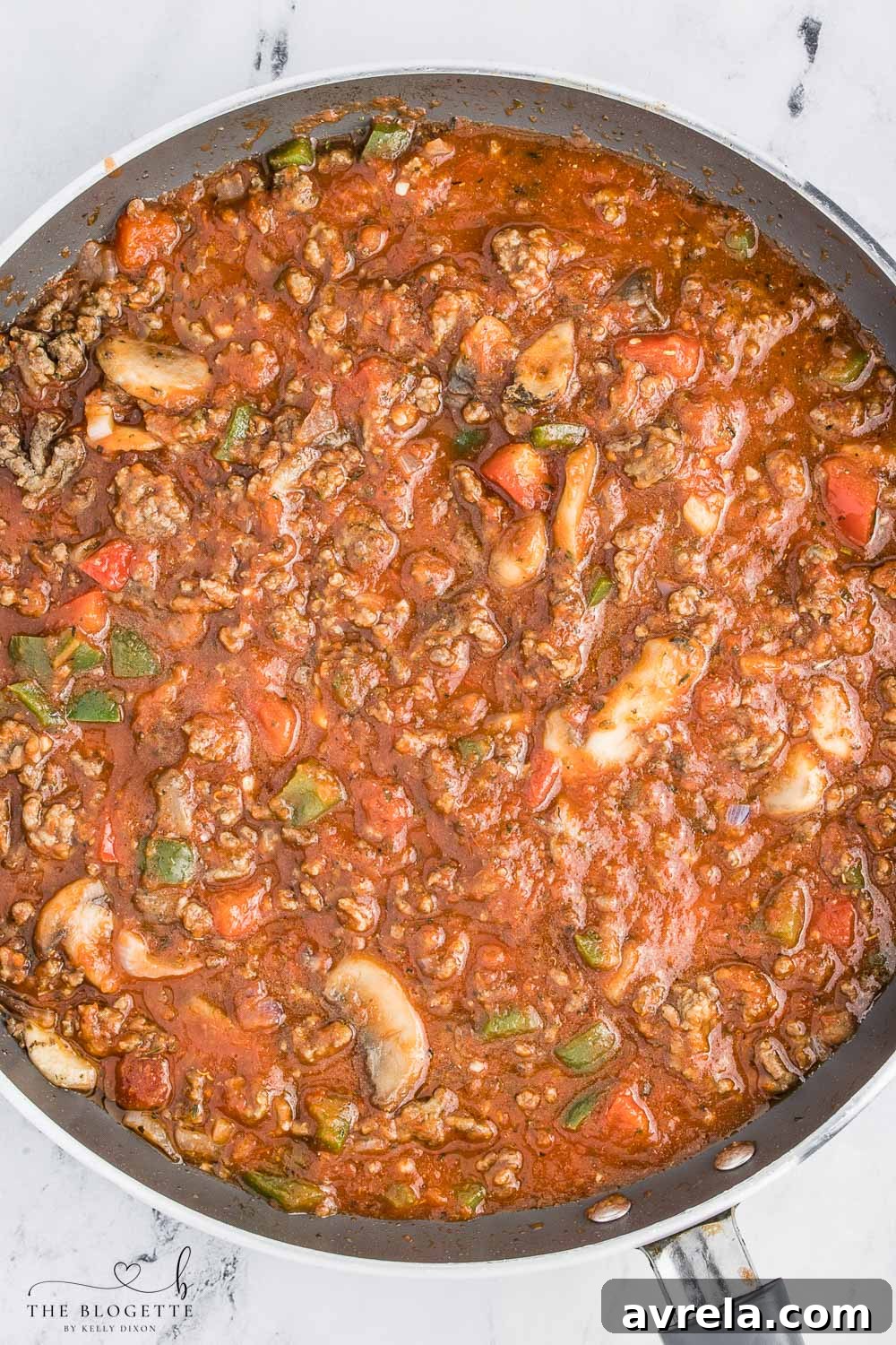 Hearty meat sauce simmering in a skillet, ready for the pizza casserole.