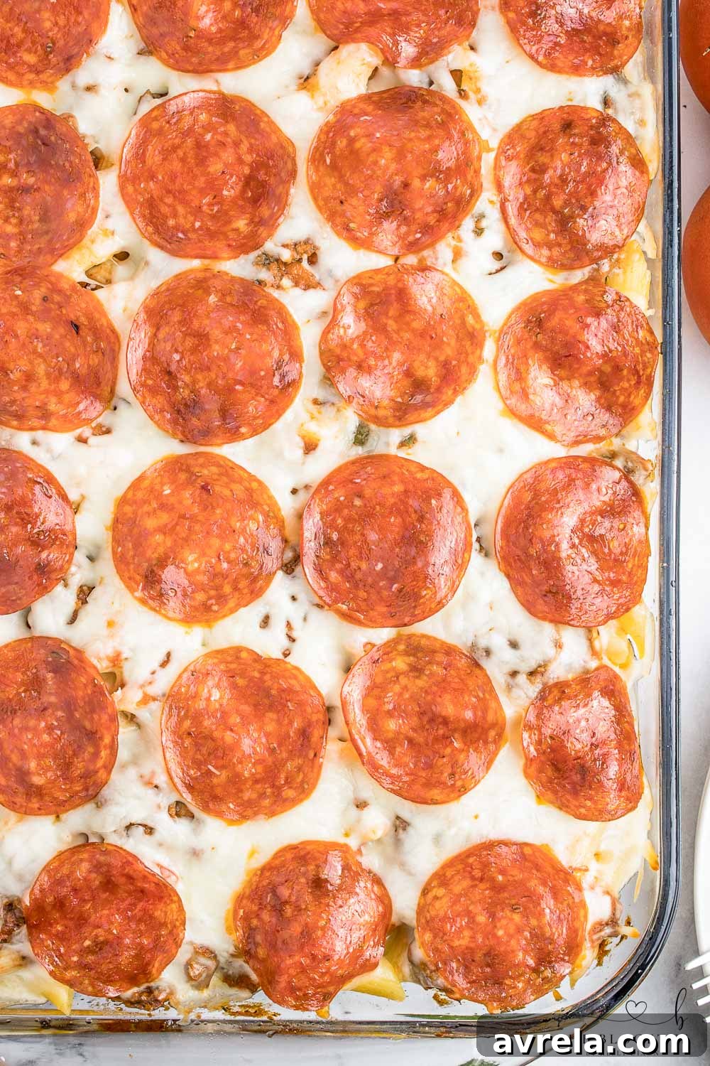 Freshly baked pizza casserole, bubbly and golden brown, with melted cheese and toppings.