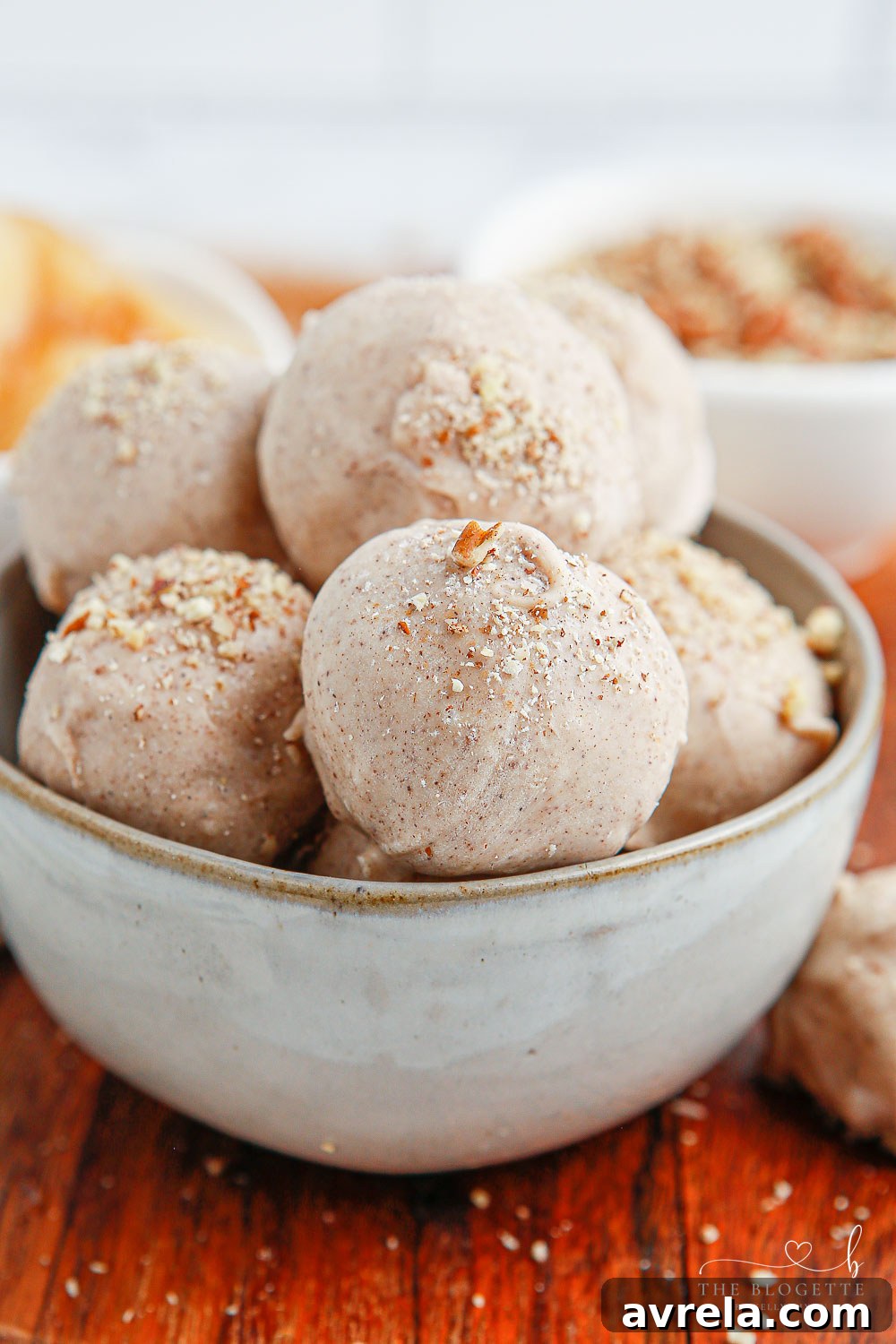 Close-up of freshly prepared Apple Pie Truffles, showcasing their smooth white chocolate coating and hint of golden deliciousness underneath.