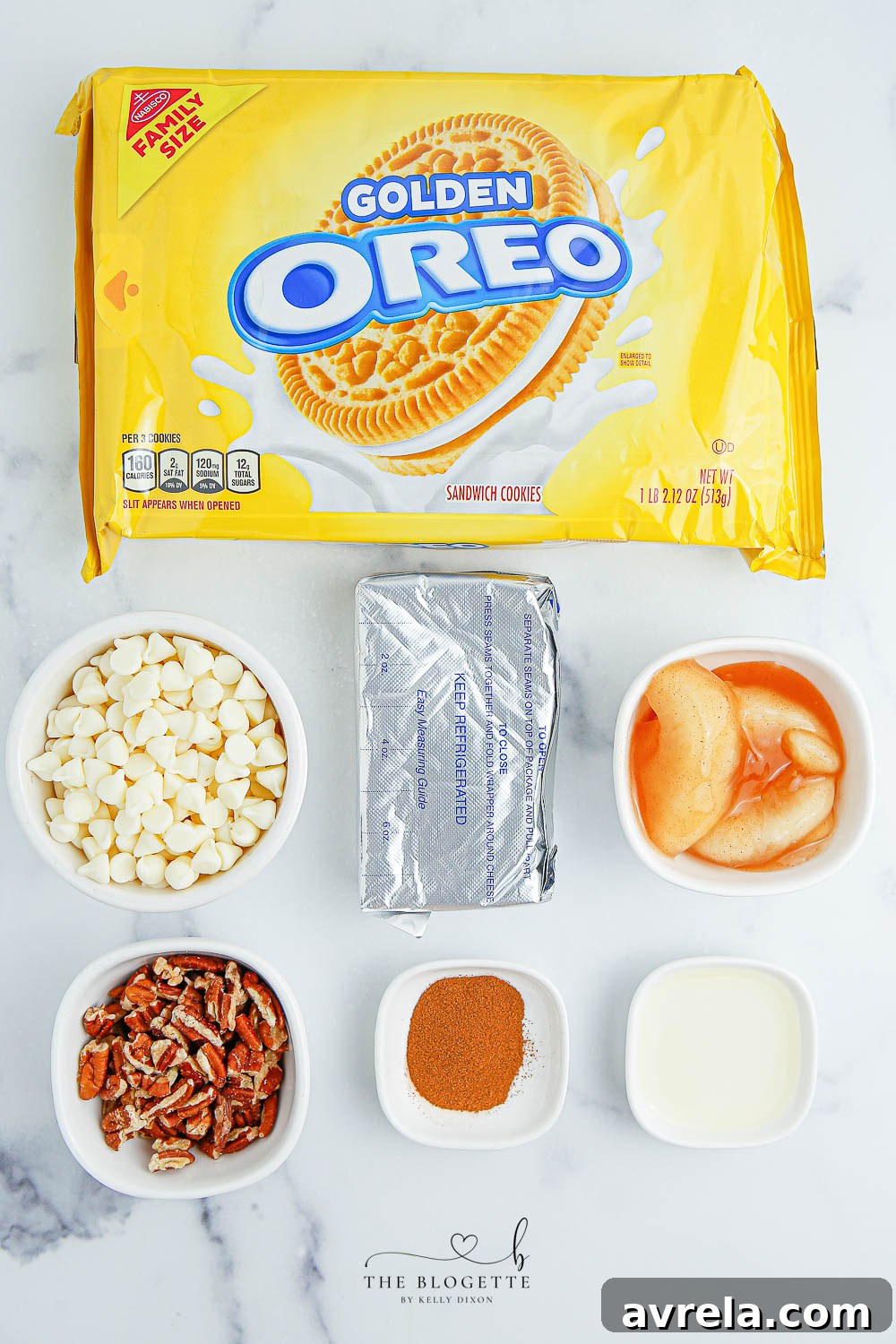 All the ingredients for Apple Pie Truffles laid out: Golden Oreos, apple pie filling, cream cheese, white chocolate, apple pie spice, and nuts.