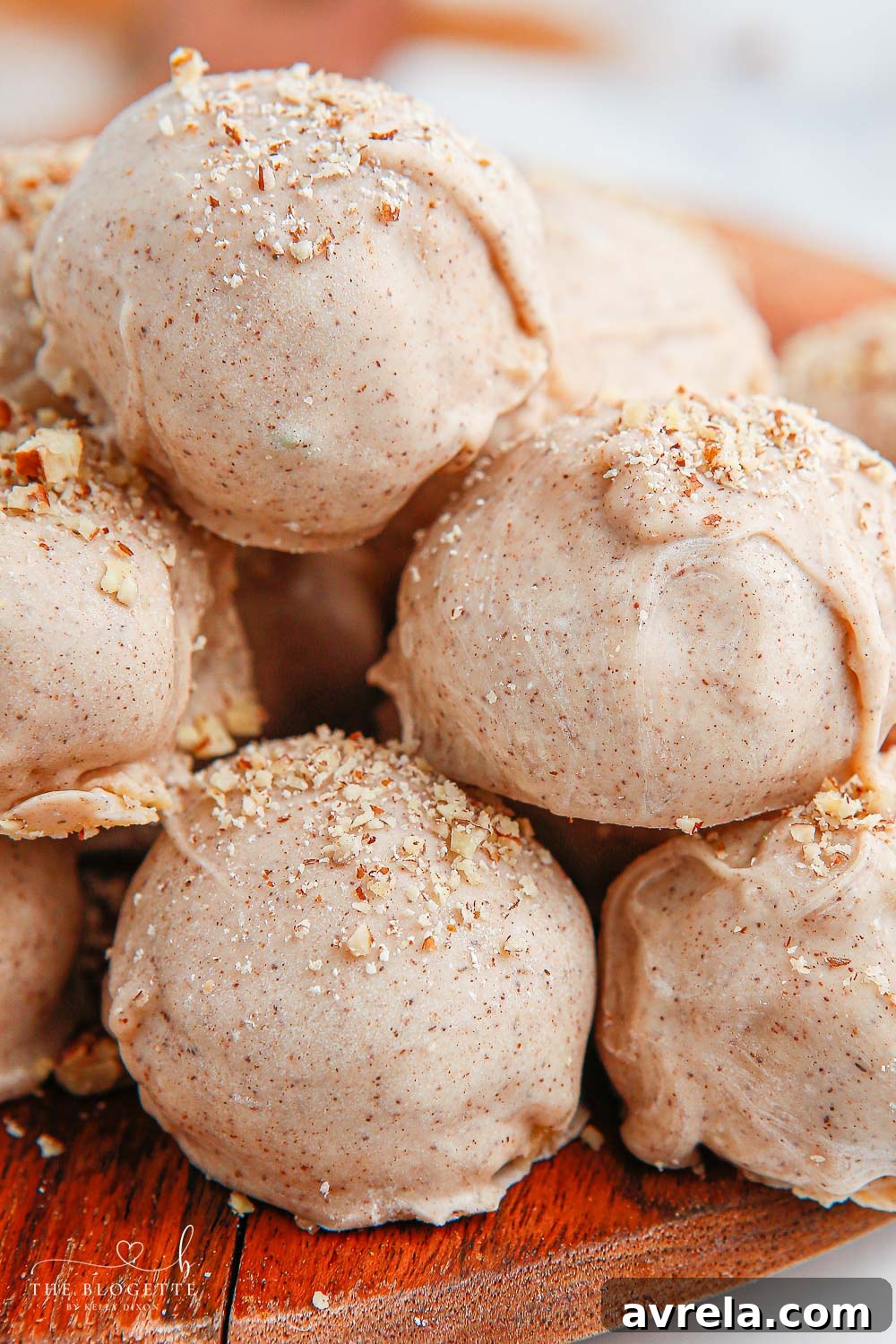 A stunning close-up of finished Apple Pie Truffles, showcasing the sprinkle of nuts and perfect white chocolate coating, ready to be enjoyed.