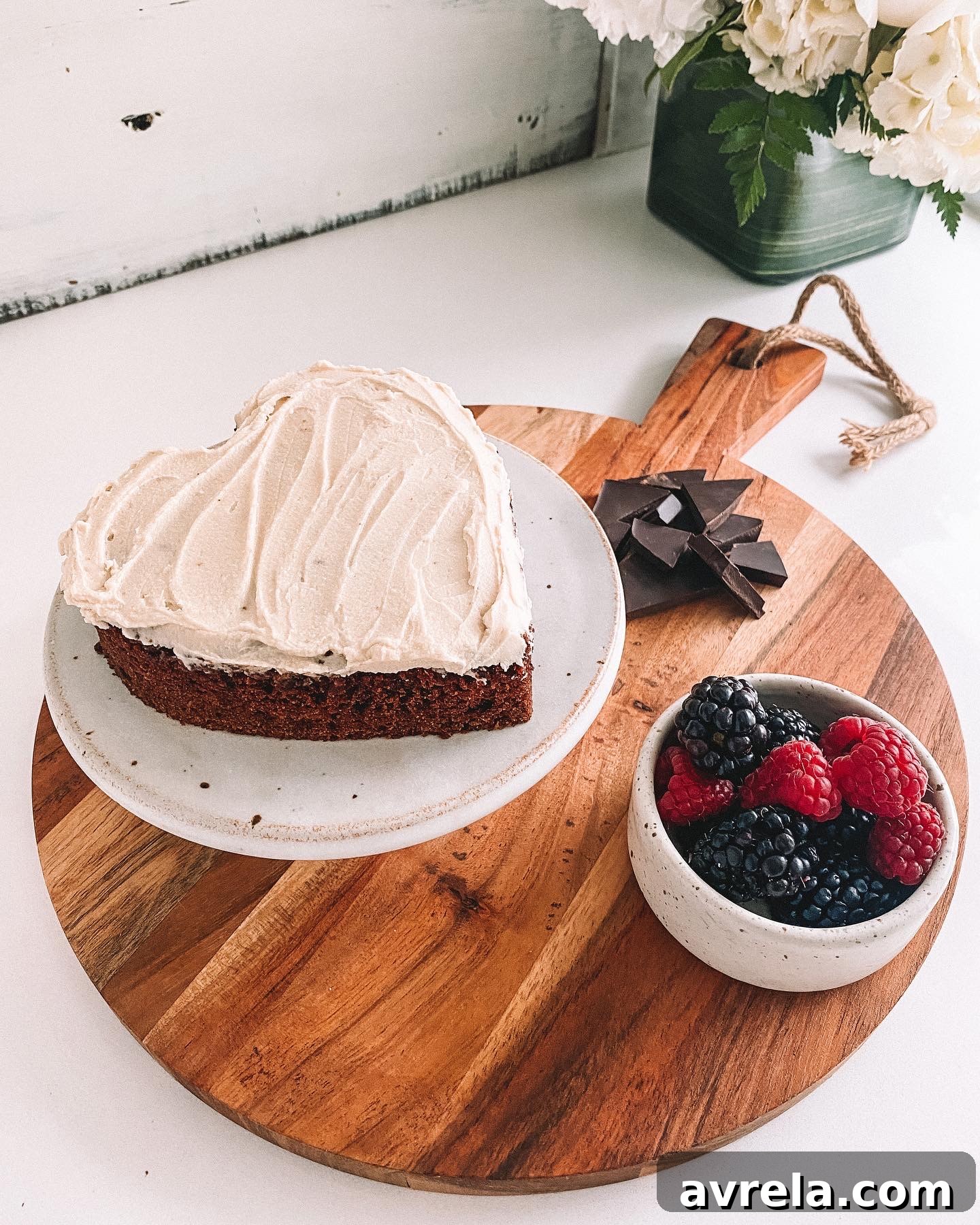 A beautifully frosted cake with dairy-free cream cheese frosting and a gluten-free vanilla base, garnished perfectly.