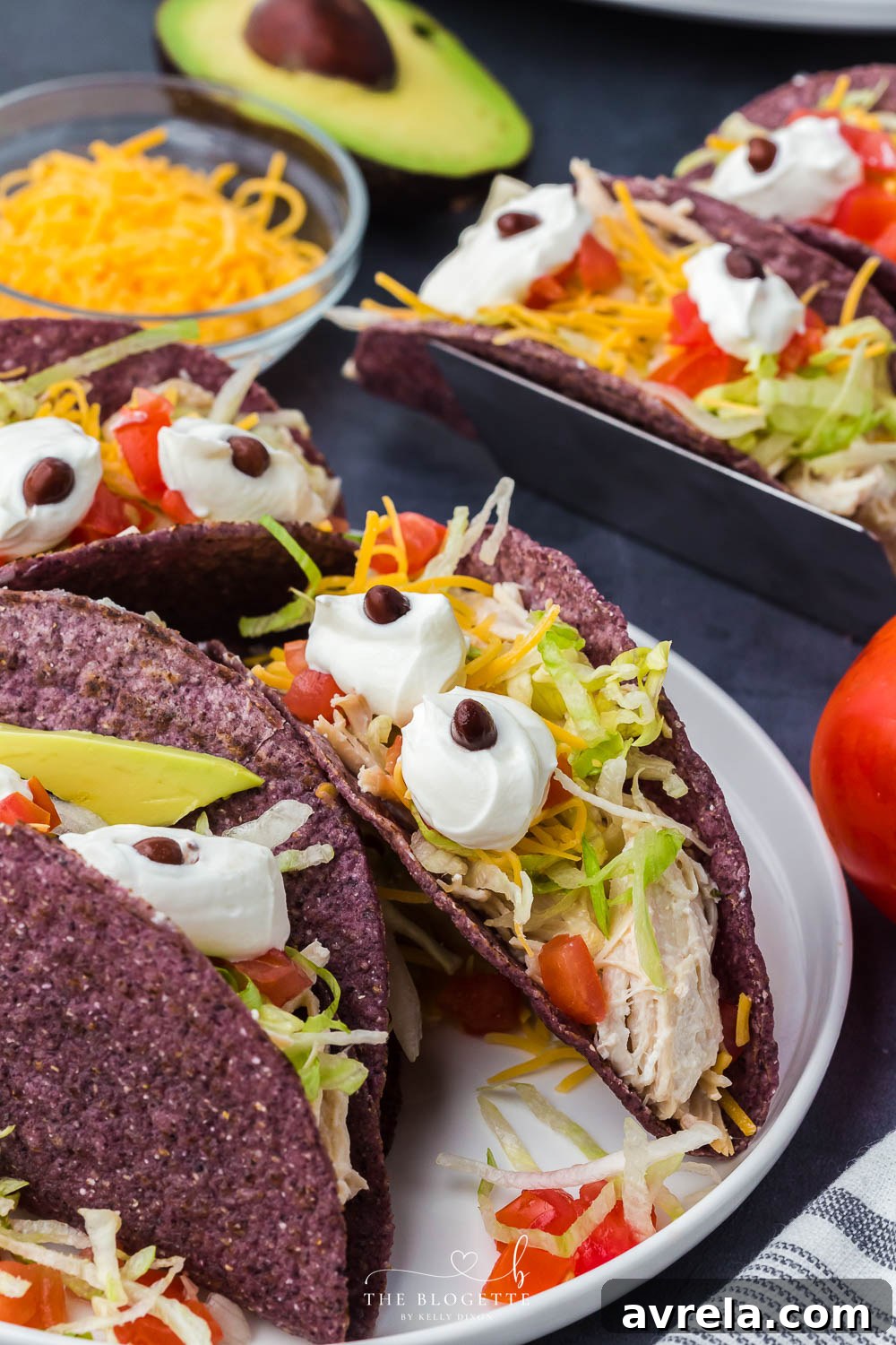 Monster Tacos for Halloween! These crock pot ranch chicken tacos feature blue corn taco shells and spooky sour cream eyes!