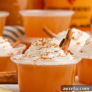 Apple Pie Jello Shots made with Fireball! Topped with whipped cream, this festive jello shot is perfect for the holidays or any fall gathering!