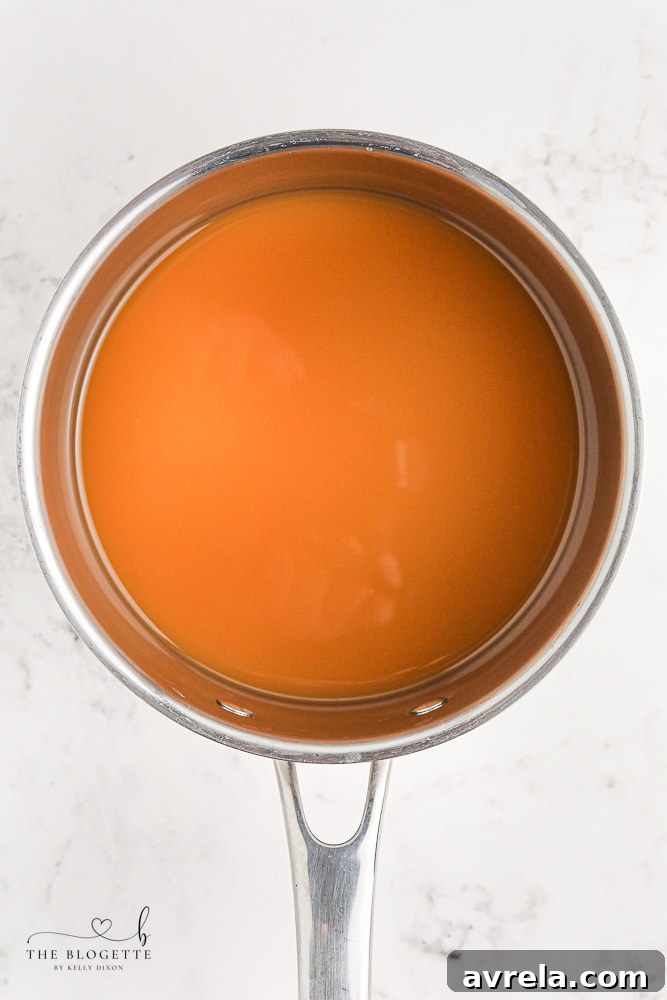 Apple cider boiling in a saucepan, the first step in making jello shots.