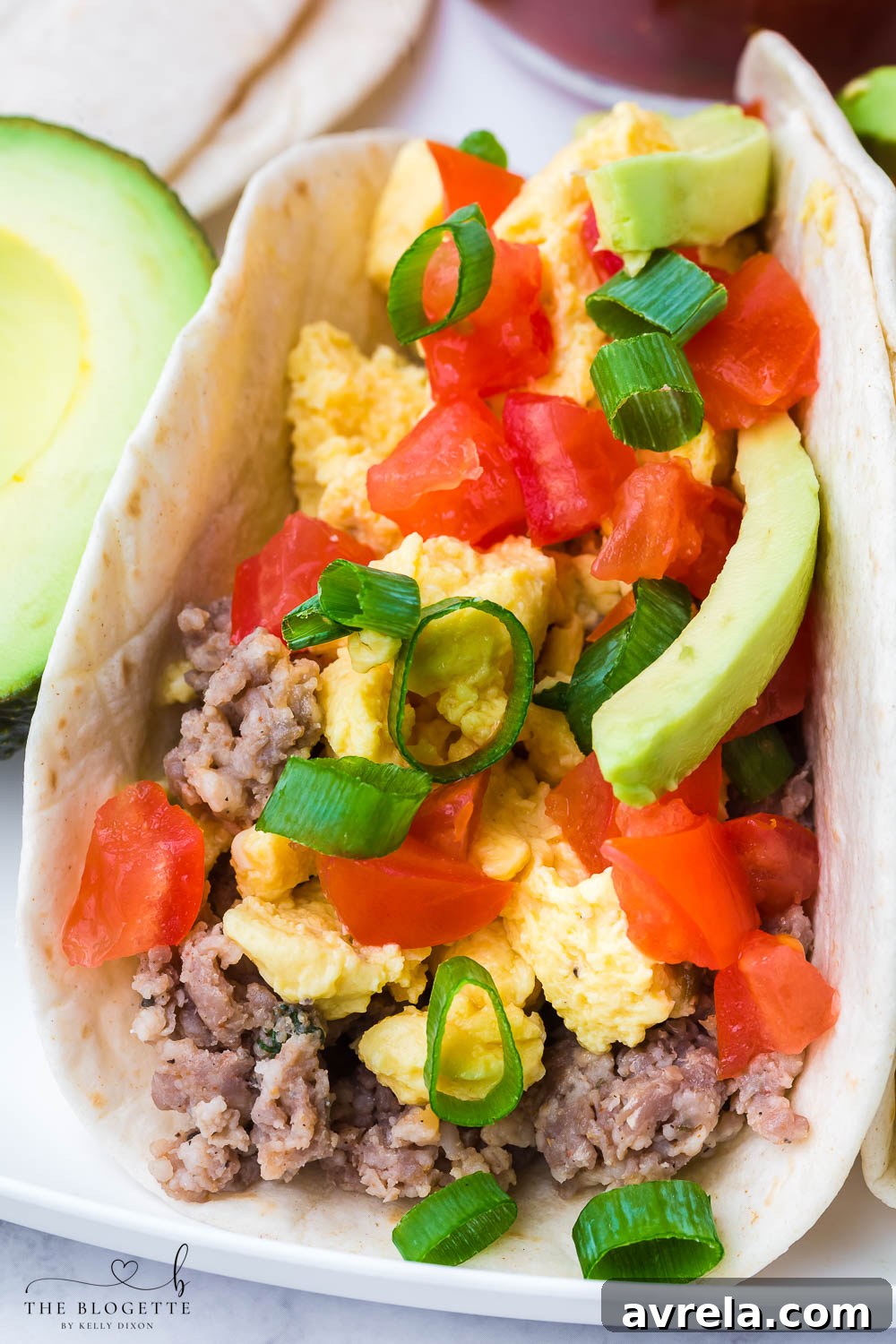 Morning Fiesta Tacos 10 A close-up of a beautifully topped breakfast taco with bacon, eggs, and fresh salsa.