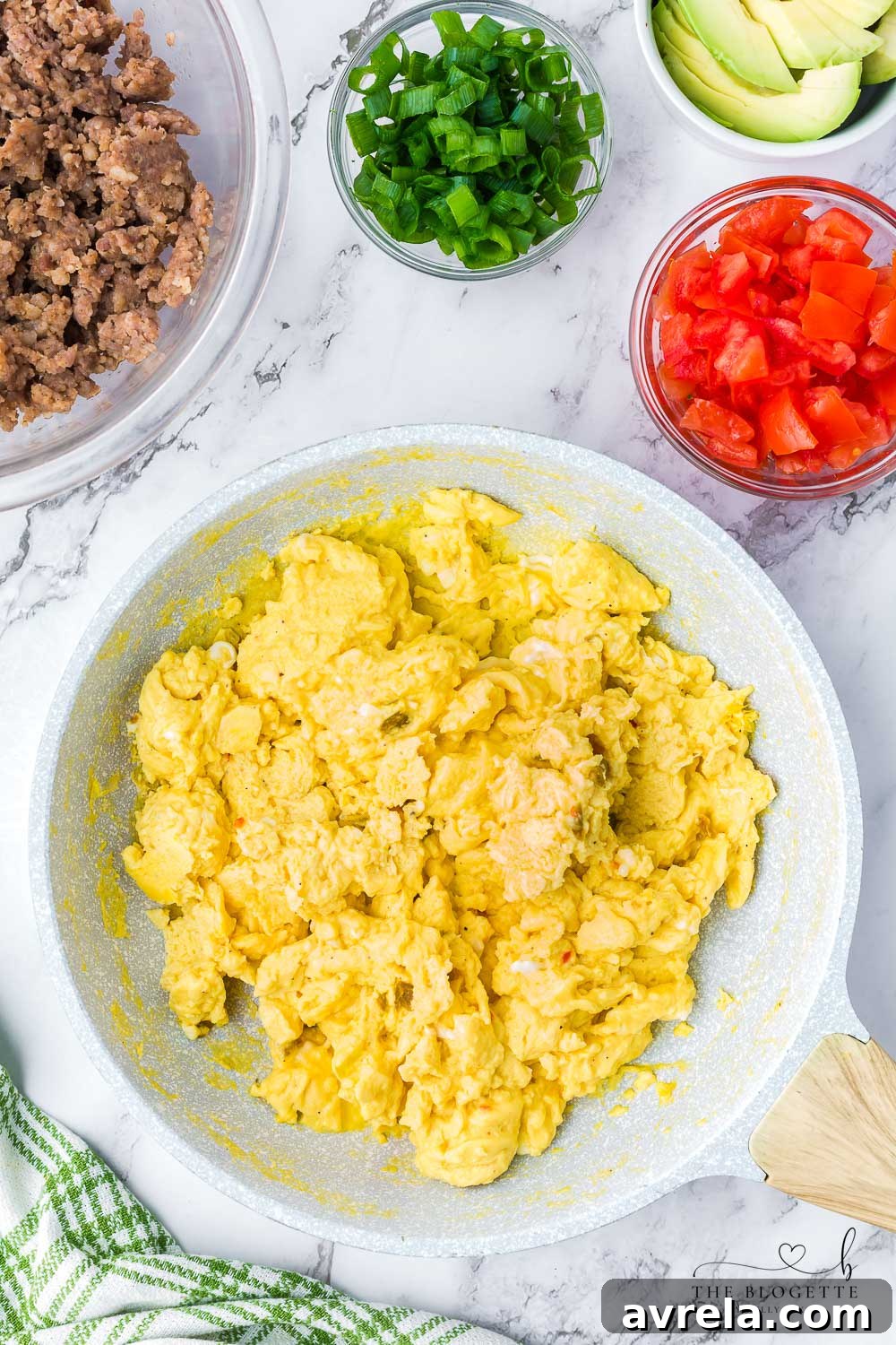 Morning Fiesta Tacos 8 Fluffy scrambled eggs cooking in a large skillet.