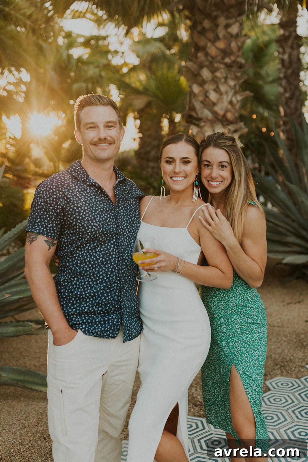 The bride and groom sharing a moment with a friendly donkey at Acre Baja farm