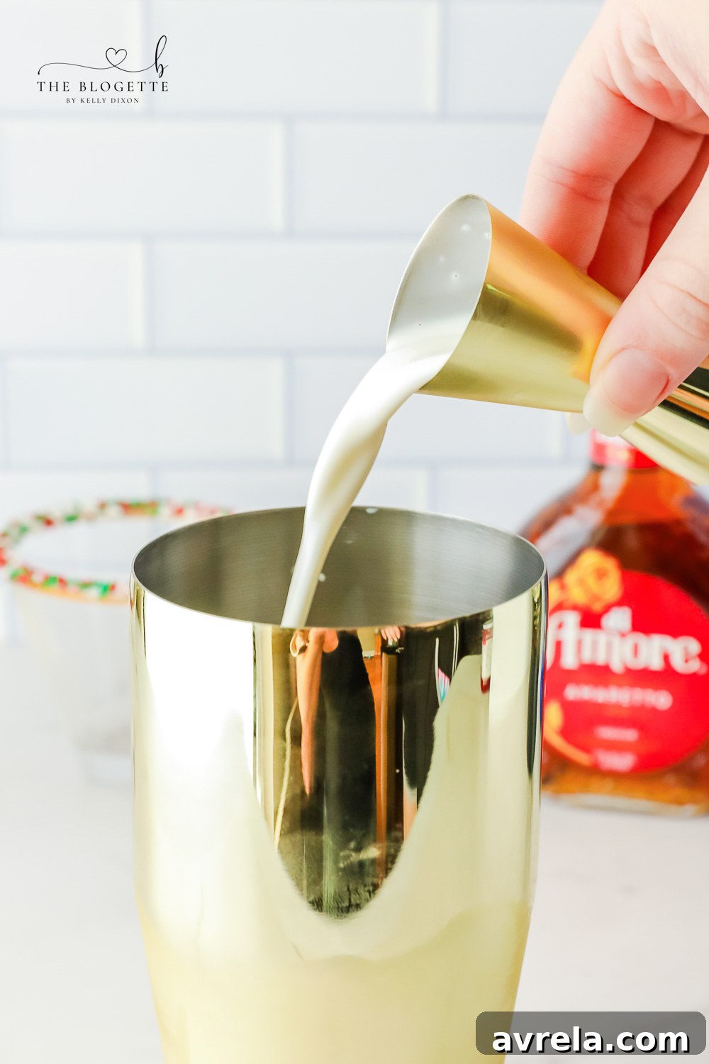 Frosted Sugar Dream 8 Pouring whipped vodka and Irish cream into a martini shaker for a sugar cookie cocktail