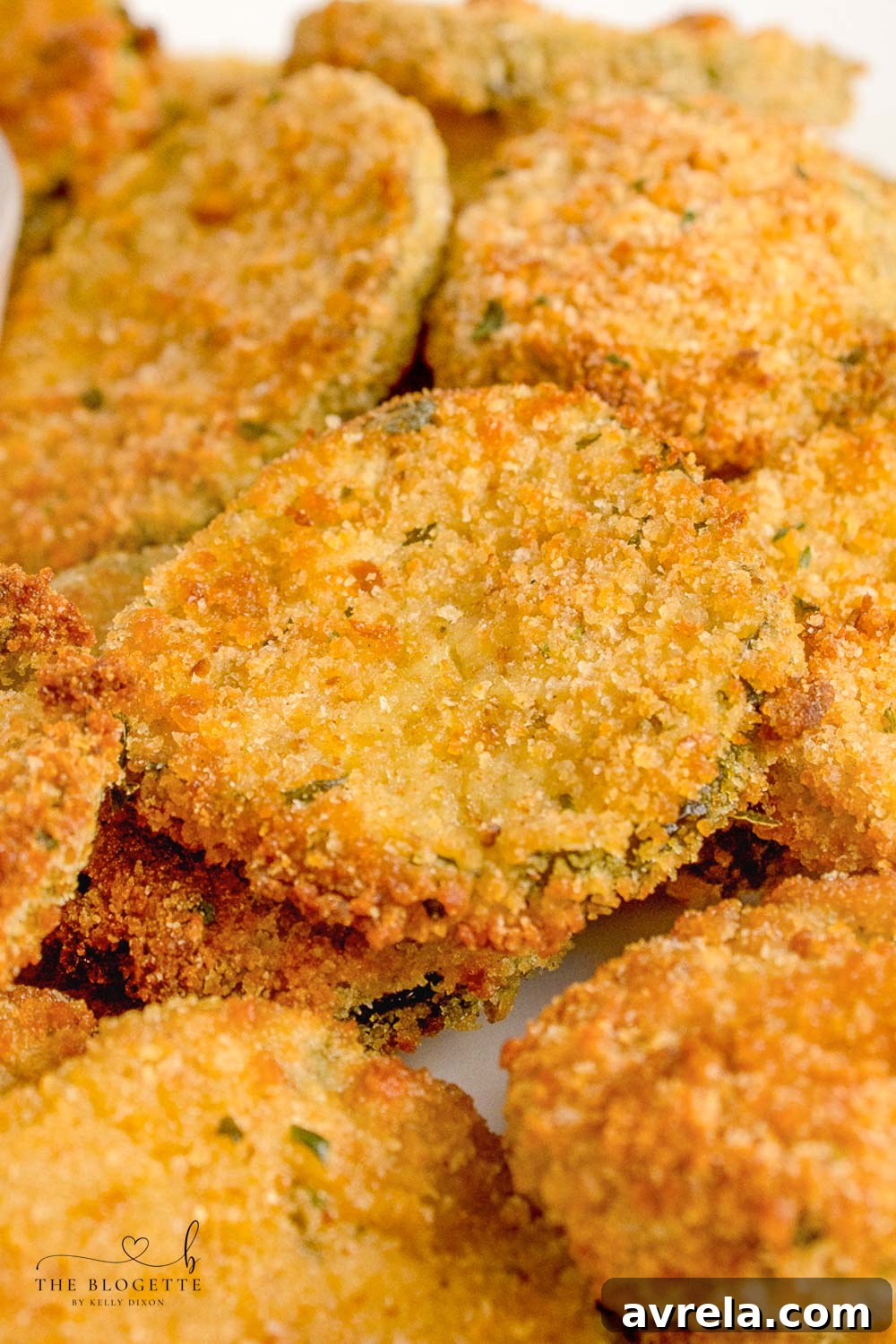 Crispy Air Fryer Fried Pickles 2 Crispy Air Fryer Fried Pickles on a plate, ready to be served with a delicious dipping sauce.