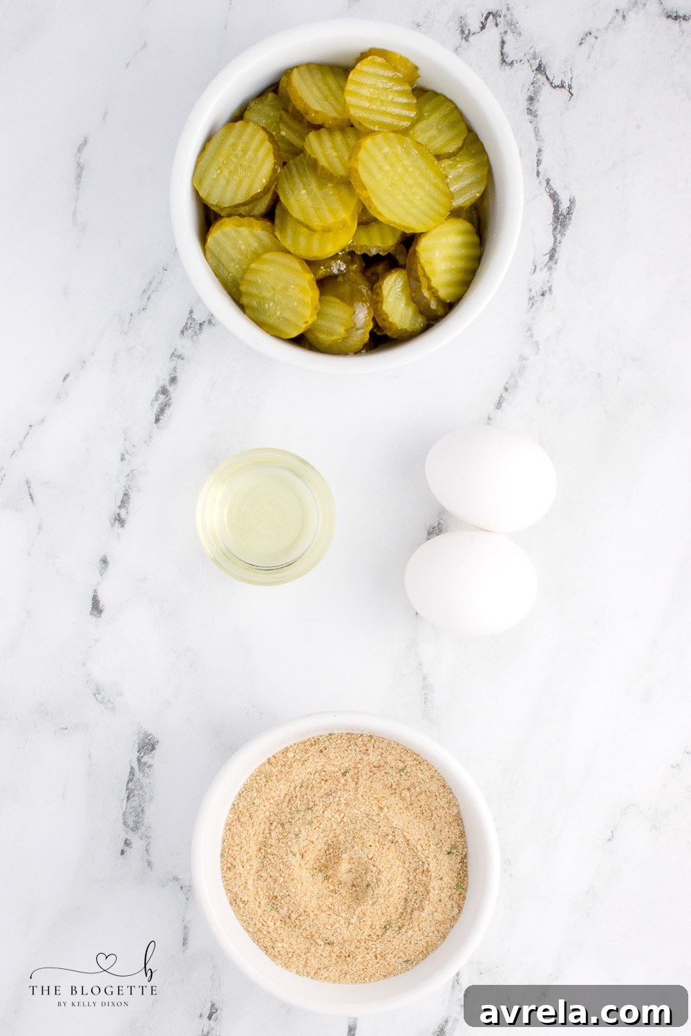 Crispy Air Fryer Fried Pickles 4 All the fresh ingredients laid out, including dill pickle chips, eggs, Italian breadcrumbs, and parsley, for making Air Fryer Fried Pickles.