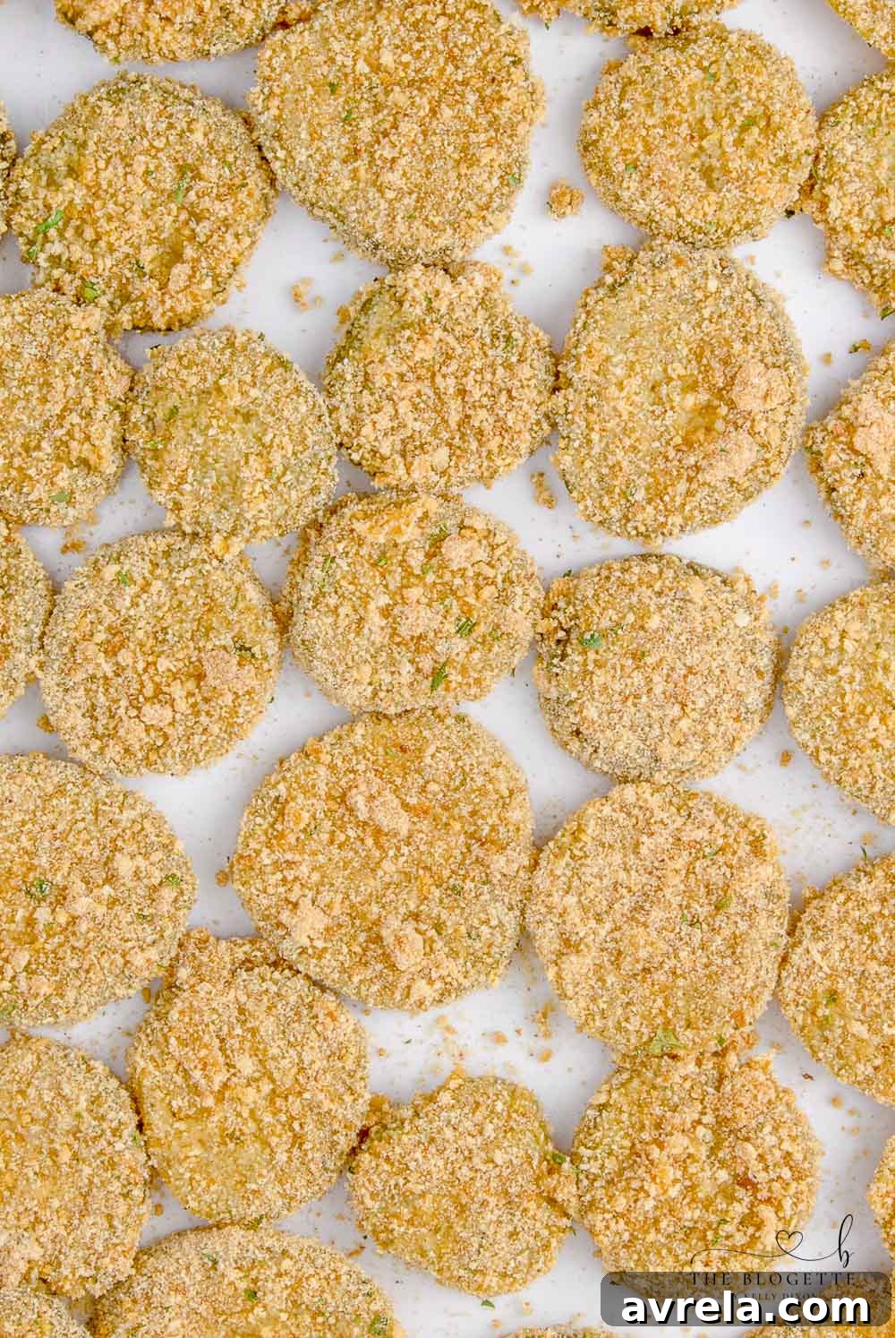 Crispy Air Fryer Fried Pickles 8 Coated pickle chips arranged in a single layer within the air fryer basket, ready for cooking.
