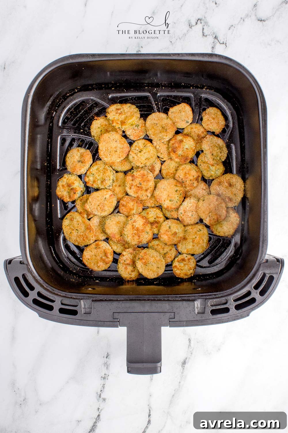 Crispy Air Fryer Fried Pickles 9 Golden brown, crispy fried pickles cooking in the air fryer basket.