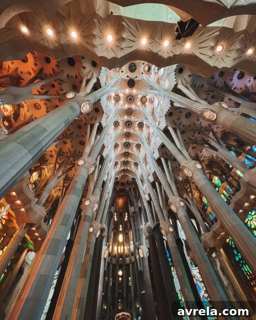 La Sagrada Familia's intricate facade, showcasing its unique architectural style and towering spires against a blue sky.
