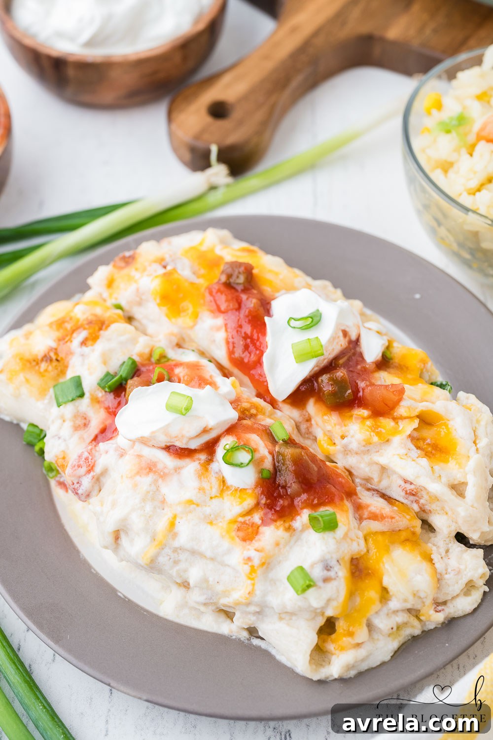 Close-up shot of the creamy white enchilada sauce bubbling in a saucepan.