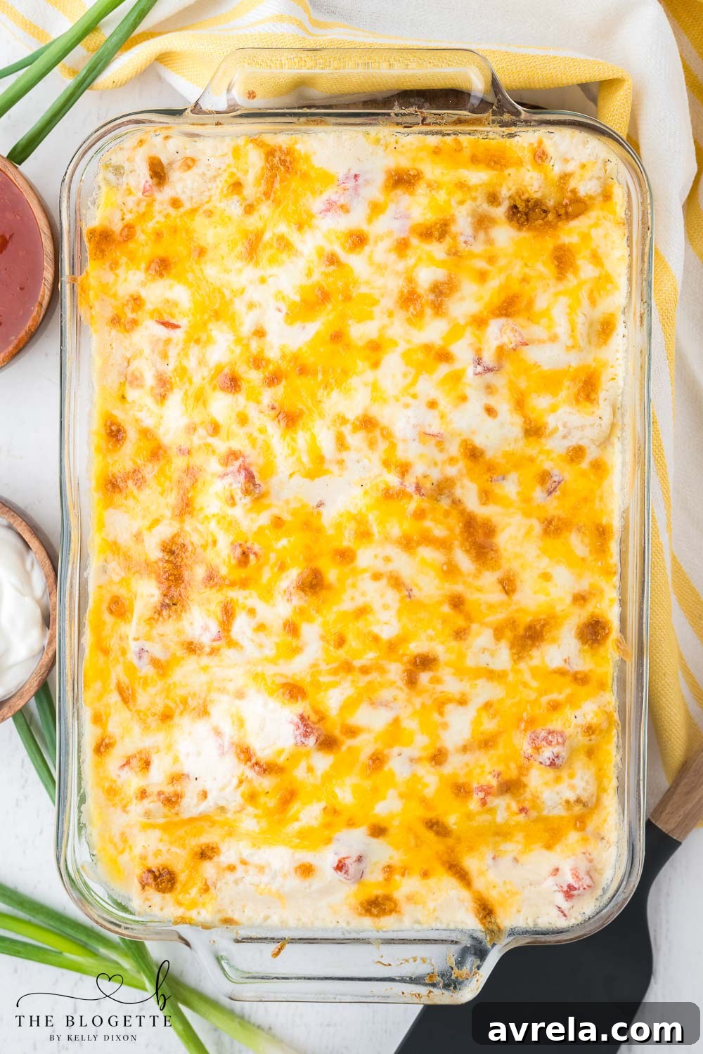 Freshly baked creamy white enchiladas with a golden brown cheese topping, straight from the oven.