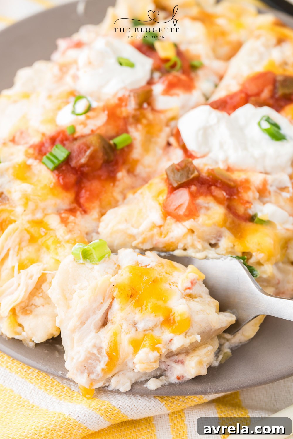 Close-up of a serving of creamy enchiladas with a rich, melted cheese topping.
