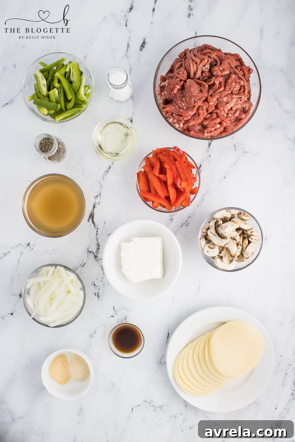 Philly Cheesesteak Comfort Bake 4 A collage of fresh ingredients laid out, including thinly sliced steak, colorful bell peppers, onions, mushrooms, various spices, and blocks of cheese, ready for the Philly Cheesesteak Casserole.