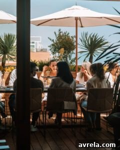 Another smiling guest enjoying the Malibu luncheon, surrounded by good company.