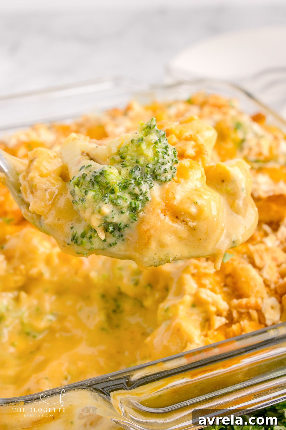 A slice of creamy Chicken Divan casserole on a plate, showcasing the layers of chicken, broccoli, and rich sauce with a crispy topping.